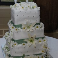 Simple Yet Elegant Friend's wedding cake. Bottom tier Chocolate Vanilla, middle tier Vanilla Chocolate, top tier red velvet with the classic cream cheese...