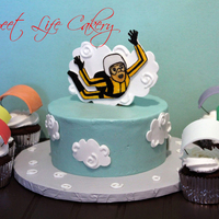 Skydiving Skydivier cake with parachute cupcakes. The clouds, skydiver, and parachutes are fondant.