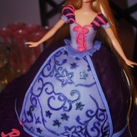 Tangled Rapunzel Cake Strawberry cake covered in Duffs Purple Fondant and Satin Ice light fondant. Whole doll inserted into doll cake mold.