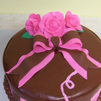 Hat Box Cake Buttercream cake with fondant top and stripes, gumpaste roses and bow. Made to looke like a hat box.