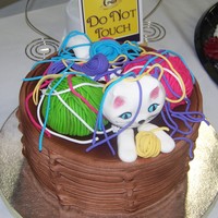 Cat In The Yarn Basket Fondant weave basket, 50/50 gumpaste/fondant cat head, paws and tail. Yarn made from fondant using clay extruder.