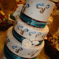 Monogrammed Cake A 3-tiered wedding cake decorated with the couple's monogram similar to that displayed on their wedding invitation.
