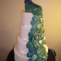 Peacock I made this cake for my daughters 13th Bday. Marble cake with oreo cookie filling. Rice crispy peacock and fondant feathers.