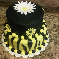 Black And Yellow/daisy/zebra Stripes Bottom tier is butter yellow, top tier is chocolate, chocolate ganache between all layers. All fondant/fondant accents, top flower is...