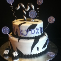 Peace Signs & Tennis Shoes 2-tier Darn Good Choc. Cake with vanilla butterecream, covered in white Satin Ice fondant. Peace signs made from gumpaste and painted with...