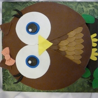 Owl Birthday Cake Strawberry cake with strawberry filling covered in chocolate ganache and fondant.