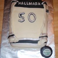 Hockey Jersey 50th birthday cake.puck is cake covered in fondant.