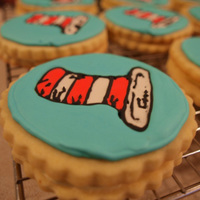 Cat In The Hat Cookies Sugar Cookie decorated with Royal Icing and sandwiched with buttercream frosting.