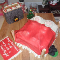 Santa And Mrs. Claus Settle Down For A Long Winter's Nap! Red velvet cake, cream cheese frosting, MMF, gumpaste. Placed on a wooden cutting board for the look of wood floors. The fireplace and bed...