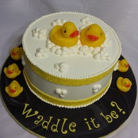 Waddle It Be? A Gender Reveal Cake! White velvet cake (dyed PINK) with white chocolate IMBC. Ducks were purchased by client. All buttercream except border ribbon and cake drum...
