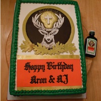 Jagermeister A choc. fondant circle semi-dried with a royal icing deer, cross and illumination. Leaves and larger circle around choc. plaque are gum...