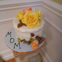 My Mom's B-Day Cake. 3 layer 8" cake. Very homestyle iced; in fact it was practically running off the cake. My gumpaste practice pieces (all roses, leaves...