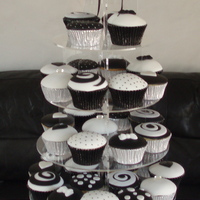 Black And White Wedding Cupcake Tower Fondant covered cupcakes, the crystal topper is also hand made by me. The cupcakes are vanilla filled with white chocolate ganache, and...