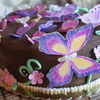 Butterflies On Chocolate Chocolate Cake, chocolate buttercream frosting. All details in fondant & gumpaste. The butterflies painted with dust colors.