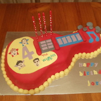 Wiggles Guitar Cake this cake is based on my son's favourite toy its a white choc mud coloured in wiggles colours, ganached then covered in fondant &...