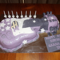 Hannah Montana Guitar Cake this is a guitar shaped mudcake, covered in ganche then detailed with icing & metal for the strings,& hand painted with silver cake...