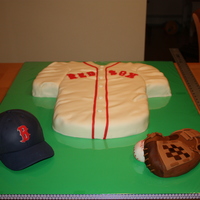 Baseball Cake The jersey is chocolate mud cake, the hat is lemon and the glove is rice crispies