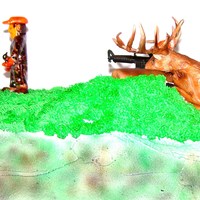 Deer Hunter Gumpaste Hunter painted in Mossy Oak Camo, credit for the deer goes to my neice Janelle, this was her first cake project and first gumpast...