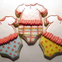 Baby Girl Onesies Ruffled baby girl onesies. Vanilla sugar cookies with a modified RI. Sorry for the poor quality photo; had to take it at night!