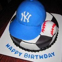 Cake For A Soccer Player Who Loes The Yankees Bottom Is A 10 Round Covered In Buttercream With Black Fondant Accents Hat Is A 6 Round Cake for a soccer player who loes the yankees. Bottom is a 10" round covered in buttercream with black fondant accents. Hat is a 6&...