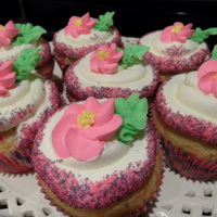 Pink And Purple Sparkles With Royal Icing Flowers Funfettic Cupcakes with Buttercream Frosting and Royal Icing Flowers.