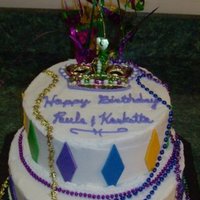 Mardi Gras Birthday Bottom tier is a 10" Chocolate, top is 8" Strawberry, butter cream icing with MMF accents. I found the beads at a local store and...