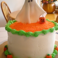 Ghost Halloween Cake Chocolate Cake filled with buttercream icing and topped with buttercream as well. The girl ghost is made from gumpaste.