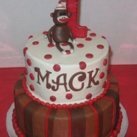Sock Monkey Red velvet cake covered with buttercream and fondant details and fondant monkey.
