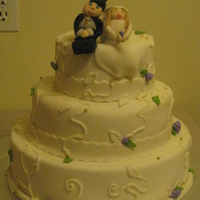 My First 3 Tier Wedding Cake White wedding cake first and bottom tier are fake with the middle being butter cake, with ribbon roses and handmade man and wife