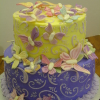 Butterflies Yellow cake covered in buttercream with buttercream details. The butterflies are made from fondant/gumpaste mix.