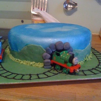 Thomas The Tank Engine This was made for a friends little boy, I sprayed the cake blue, and this time used die cast engines for him to play with afterwards.