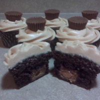Peanut Buttercup-Cakes Double chocolate cupcake with a reese's inside, topped with peanutbutter buttercream and another reese's