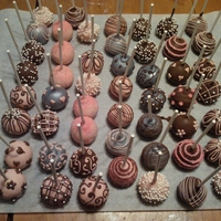 Classic Pink, Brown And Silver chocolate cake pops with a peanut butter center.