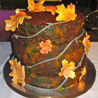 Chris' Grooms Cake Tree stump grooms cake with barbed wire and fall leaves.