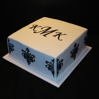 Black Damask Stencil On White Buttercream With Monogram This is a 10 inch square cake. White Vanilla Cake with White Buttercream Frosting. Strawberry Fruit Filling. Black Damask Stencil and...