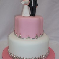 Pink Sparkle Wedding Cake Pink and white wedding cake with bride and groom