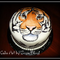 Kymee's Tiger This is a white cake with vanilla filling, frosted with buttercream icing and then covered in MMF. I painted the tiger on the MMF with...
