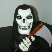 Grim Reaper I used the Wilton 3D pan for the head and an 8" round cake underneath. The robes are Satin Ice fondant, and I used mmf for the rest of...