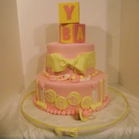 Baby Shower In Pink And Yellow Cake covered in MMF, block are wilton candy melts in a mold, pacifier and everything else is MMF, hand made. They loved it. cake is...