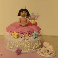 Princess Dora's 1St Birthday! Two tier Vanilla cake filled with buttercream. Fondant/gumpaste Dora, Boots and details.
