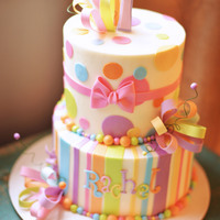 Girly Whimsical 1St Birthday Cake Buttercream cake with fondant accents, edible bows, and a few little curly wires for some sass!