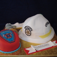 Fire Chief Retirement Cake Helmet was a carved yellow cake with fondant. Badge cake was chocolate and fondant, fire hose was rice treats covered in white chocolate...