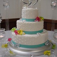 Calla Lilies With Jewels Dots And Swirls 14- 10- 6" round all done in buttercream with calla lilies and diamonds decorated with dot and swirls and grosgrain ribbon