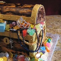 Treasure Chest Chocolate cherry cake with cream cream frosting covered with fondant. I use a wood grain tool to create the wood look!