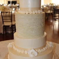 Vintage Wedding Cake Carrot cake with cream cheese filling and buttercream frosting. Tall tier with strands of pearls is a dummy cake (Styrofoam). Small roses...