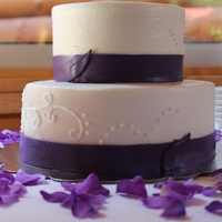 Plum Elegance buttercream with fondant ribbon.