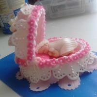 Baby Bassinet Bassinet made out of pressed sugar and covered in fondant and some royal icing details.
