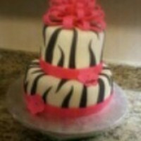Zebra Birthday Cake White and chocolate cake layered to look like zebra stripes inside when cut. Covered in buttercream, then fondant. Fondant ribbon and bow...