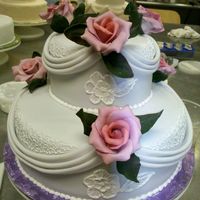 Toba Garrett's Wedding Cake Workshop Two tier vanilla cake with lemon and lime curd filling and French vanilla buttercream. Hand molded white chocolate roses and leaves,...