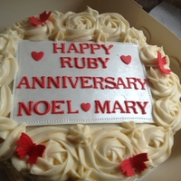 Red Velvet Ruby Anniversary Cake Red Velvet cake with cream cheese frosting. Gumpaste plaque on top. Served with 36 red velvet cupcakes.